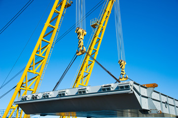 Loading in port. Floating port crane on blue sky background