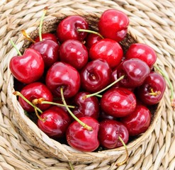 Wicker basket with red cherries