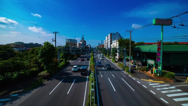 A timelapse of downtown street at Kanpachi avenue in Tokyo daytime wide shot tilt