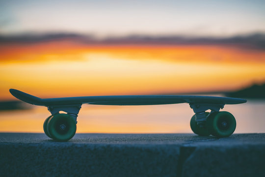 skateboard on the background of the sky at sunset