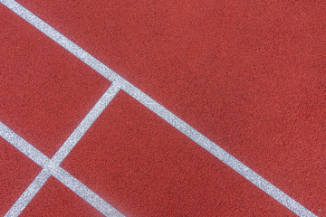 Colorful sports court background. Top view to red field rubber ground with white lines outdoors