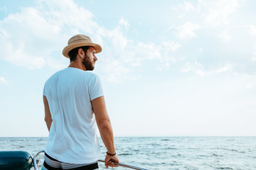 Young man enjoying a view of the sea from the boat