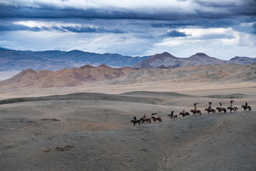 Fototapeta na wymiar West Mongolia group of eagle hunters exploring Altai landscape