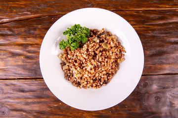 Seeds of buckwheat cereal with fried mushrooms and onions with parsley
