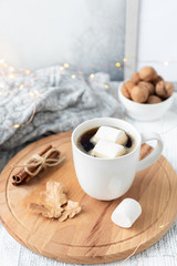 Mug with coffee and marshmallow, sweater, cinnamon, decorated with led lights. Autumn mood. Cozy autumn composition. Hygge concept Soft focus - Image