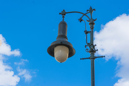Vintage street lamp against the blue sky