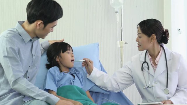 Asian doctor visit patient little girl and suggest physical examination at hospital. Concept of family, medical, healthcare and technology.