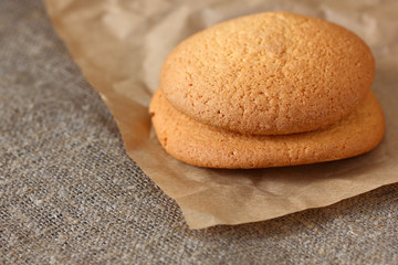 Oatmeal cookies two pieces on paper wrapping kraft and burlap tablecloth
