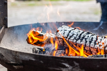Burning logs on a grill.
