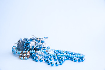 Blue bracelet and beads of blue colors on a light blue background.