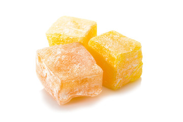 Turkish delight. Honey rahat locum, three pieces of of sweet oriental delights in powered sugar. Close-up view.