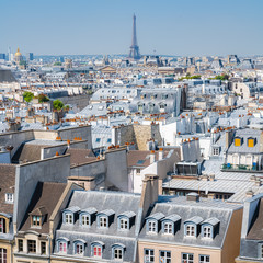 Paris, typical buildings and roofs in the Marais, aerial view from the Pompidou Center, with the Eiffel Tower in background 