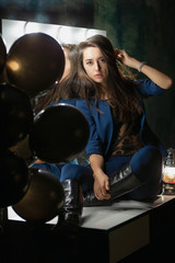 Adorable young lady posing while sitting.