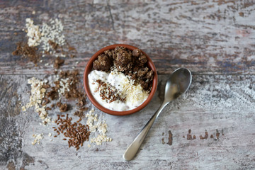 Healthy breakfast with white yogurt, chia, seeds and chocolate granola. Fitness breakfast. Vegetarian food. Keto diet. Selective focus. Macro.