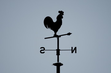A vane with a cock in a clear blue sky in Cantabria, Spain