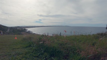 Paraglider Paragliding. People Crowd Watching Para Glider Flying High In Windy Cloudy Sky At Pat Morton Lookout Headland Sea Coastline Hills.Outdoor Leisure Activity.Lennox Head Landscape Australia