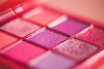 Eye shadow palette in pink shades closeup. Make up product. Selective focus.