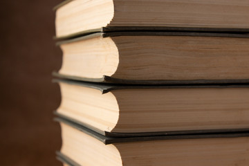 Old books on brown background close up