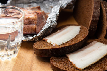 Lard with black bread and a shot glasses with alcohol