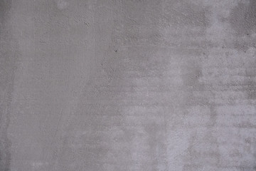 Fototapeta premium Abstract gray background. Rough concrete wall covered with cement