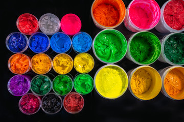 several color plastisol ink cans in factory who use plastisol ink to print tee shirt and print on fabric. .including shades of warm color and shades of cool color.