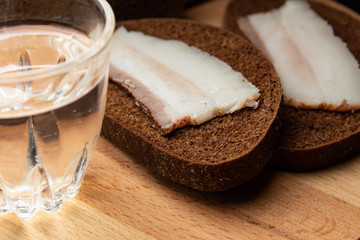 Lard with black bread and a shot glasses with alcohol