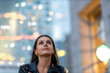 Portrait of young woman in the city at night © pikselstock
