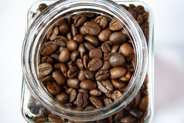 Coffee beans visible in the unscrewed jar