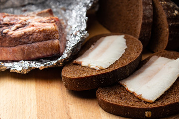Lard with black bread on a wooden board