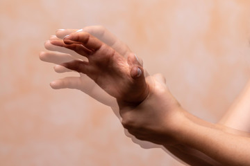 hands pain concept,Closeup view and motion blur of left Hand grab right hand, Woman or man holding her wrist pain