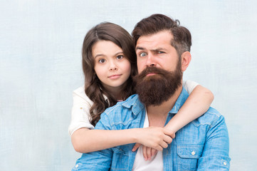 My father is the best. Small girl child hugging father on grey background. Bearded father and little daughter grimacing and having fun together. My father is my friend.