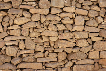 Stone wall made with rocks without concrete.