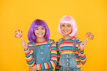 Sweet life. Anime cosplay party concept. Happy little girls. Anime fan. Kids with artificial hairstyles eating lollipops. Anime convention. Vibrant characters fantastical themes. Modern childhood