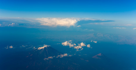 Fototapeta na wymiar Mountain Ararat volcano in Turkey (5137m altitude) and Little Ararat in the right. aerial view from airplane