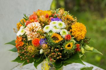 Colorful flower bouquet on a garden chair in a garden