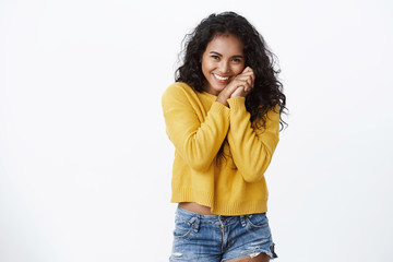 Lovely tender and feminine african american woman, curly-haired in yellow sweater, silly laughing,...