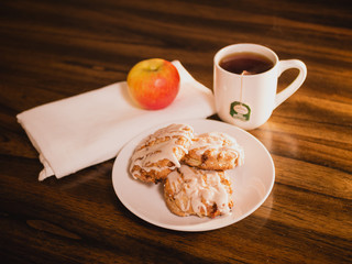 gourmet morning breakfast with scones, apple, and a cup of tea