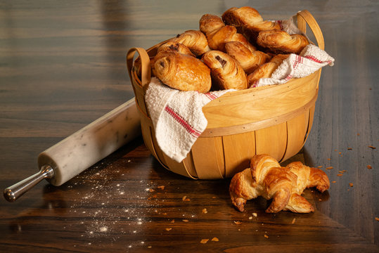 country style basket of breakfast breads, pastries, and croissants