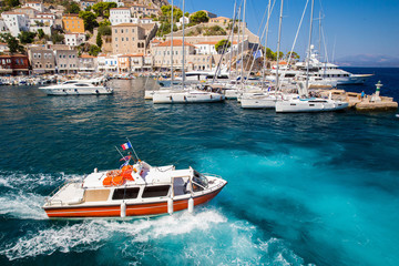 Boat - water taxi  in harbor of   majestic  Greek island   Hydra