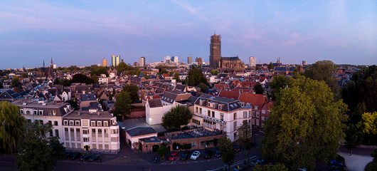 Aerial view of the medieval Dutch city centre of Utrecht with cathedral towering over the city at early morning blue hour sunrise