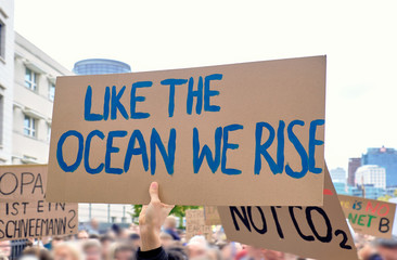 Placard "Like the ocean we rise" on global climate strike in Berlin