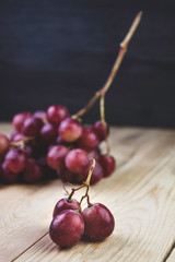 GRAPES ISOLATED ON WOODEN TABLE. VINTAGE TIME