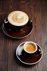 Cappuccino on a brown wooden background. Menu