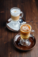 Cappuccino on a brown wooden background. Menu