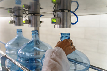 Empty plastic bottles or gallons on conveyor belt machinery equipment for checking plastic...