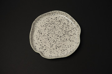 ceramic dishes: plates and gravy boats on a black background