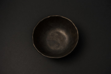 ceramic dishes: plates and gravy boats on a black background