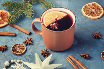Brown Ceramic Cup with Red Warming Mulled Wine Made from Cinnamon Stick, Anise and Sliced Orange. Creative Photo with Alcohol Drink Decorated Pine Branch, Xmas Toy and Ingredients. Seasonal Beverage