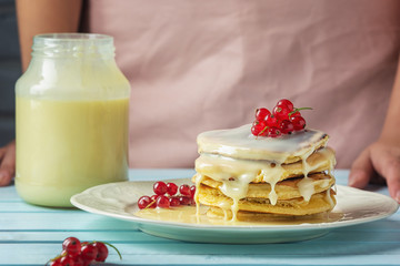 Pancakes with condensed milk. Tasty breakfast with red currant berries.