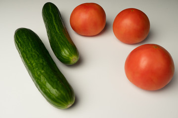 Vegetable shot on a white background: Cucumbers, tomatoes
